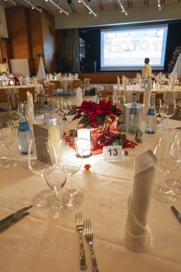 An elegantly set table with Christmas decoration and candle light, Christmas party Dekra