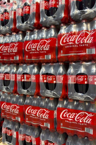 0.5 half liter plastic PET bottles stacked in plastic packs with sugary caffeinated beverage soft