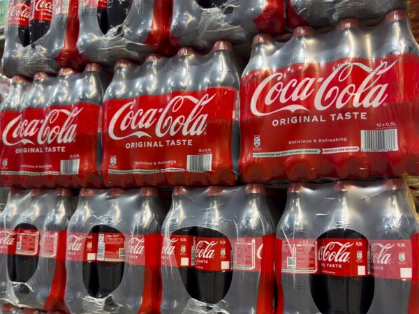 0.5 half liter plastic PET bottles stacked in plastic packs with sugary caffeinated beverage soft