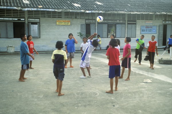 Students in a schoolyard in the stilt village of Ko Pannyi in Phangnga Bay near Ko Phuket, two