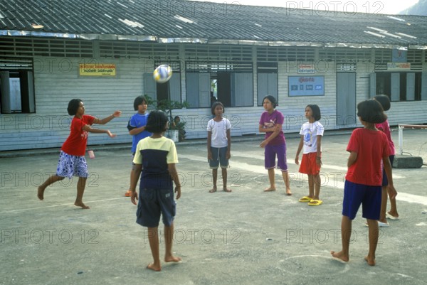 Students in a schoolyard in the stilt village of Ko Pannyi in Phangnga Bay near Ko Phuket, two