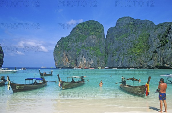 People, longtail boats on Maya Bay beach, known from the movie The Beach, one year in front of the
