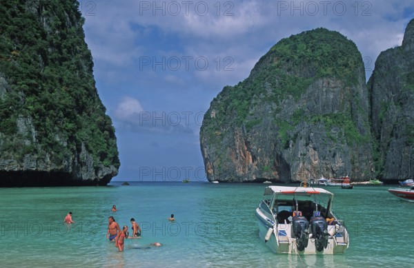 People, boats on Maya Bay beach, known from the movie The Beach, one year in front of the tsunami,