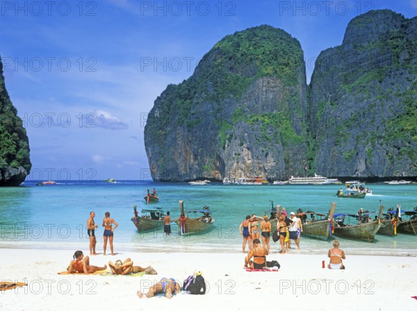 People and longtail boats on Maya Bay beach, known from the movie The Beach, one year in front of