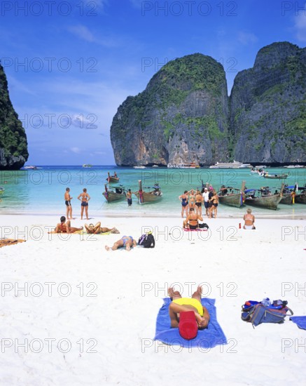 People and longtail boats on Maya Bay beach, known from the movie The Beach, one year in front of