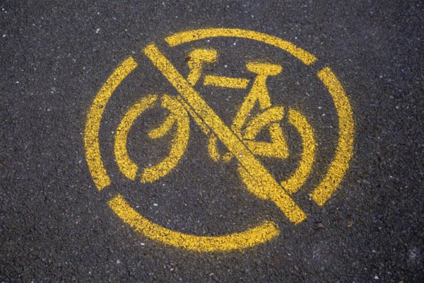 Yellow no cycling sign spray painted on tarmac path surface, Horniman, Museum, Forest Hill, London,