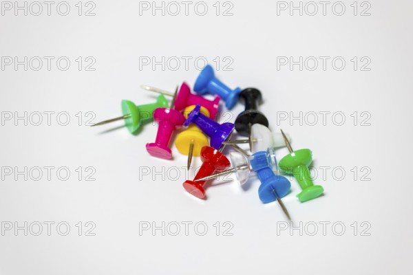 Colourful drawing pins arranged on a neutral background, Germany