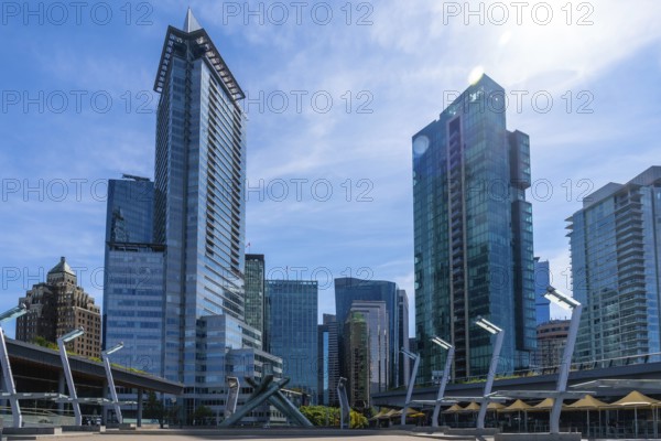 Sunlight illuminates modern skyscrapers and office buildings in vancouver, british columbia,