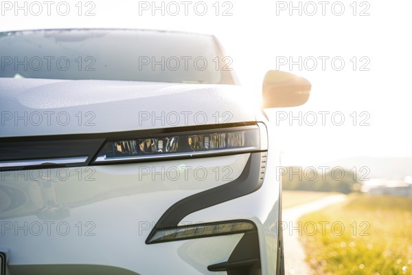Front part of a white car with modern headlights in sunny surroundings, Deer E-Carsharing, Renault