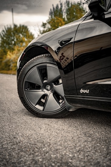 Detailed view of a car tire on a grey road surface, Deer e-car sharing, Tesla Model 3, Calw,