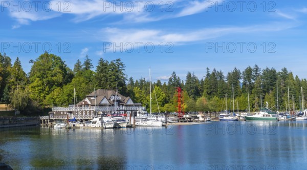 Panoramic view of the stanley park seawall with moored sailboats and yachts in coal harbour,