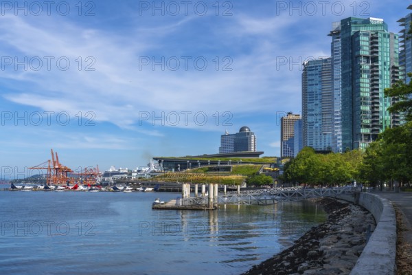 Modern skyscrapers rising along vancouver's waterfront create a stunning cityscape, bustling with