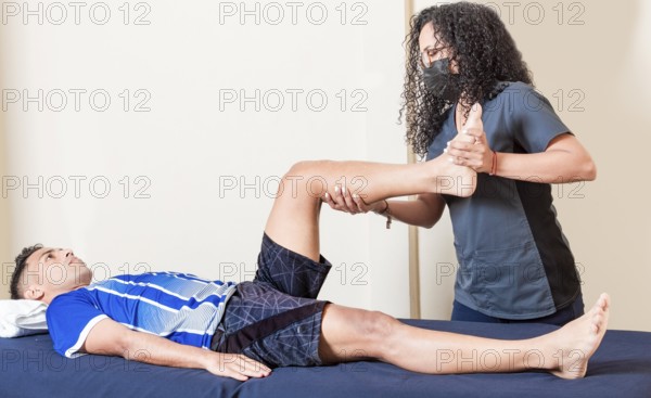 Physiotherapist checking patient leg. Orthopedic specialist helping a patient with a leg injury.