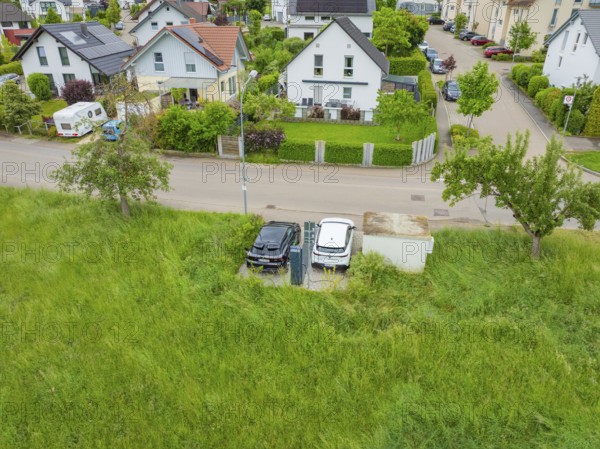 Aerial view of a residential area with street surrounded by green nature, Deer E-Carsharing, Calw,