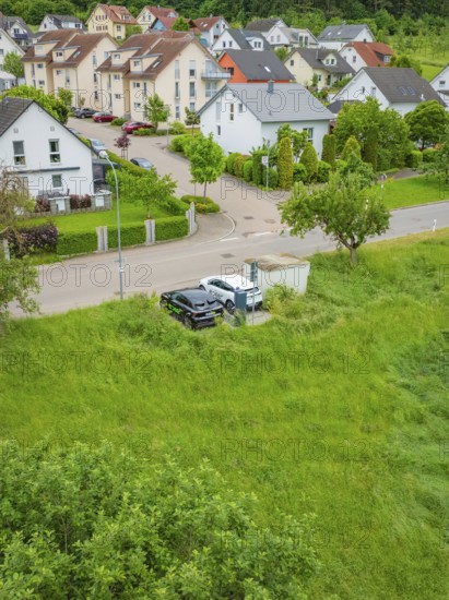 Aerial view of a residential area with adjacent road and lots of greenery, Deer E-Carsharing, Calw,