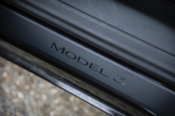Close-up of Model 3 lettering on black metal, Deer E-Carsharing, Tesla Model 3, Calw, Germany