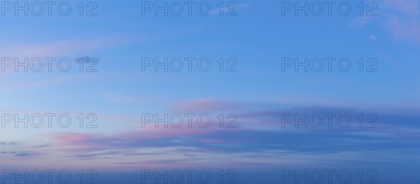 A beautiful twilight sky showcases vivid pink and blue colors as the sun sets, creating a serene