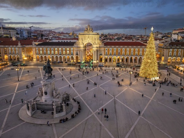 Praca do Comercio glows in the evening with a decorated Christmas tree and festive lights, creating