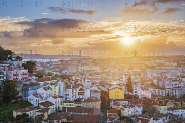 Stunning sunset over Lisbon at Miradouro da Senhora do Monte, with views of Carmo Convent and the