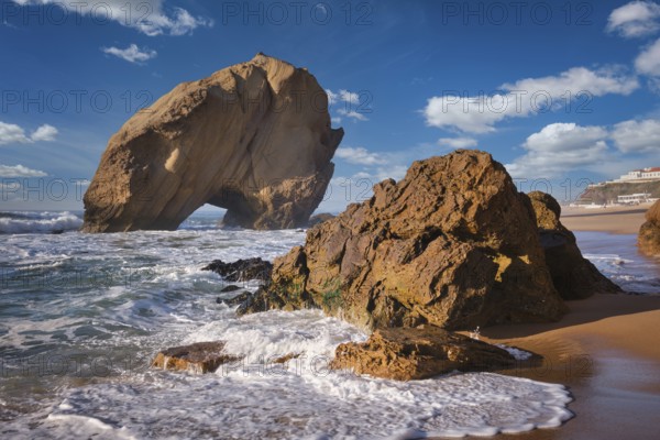 Penedo do Guincho stands majestically at Praia da Santa Cruz, surrounded by ocean waves as the sun