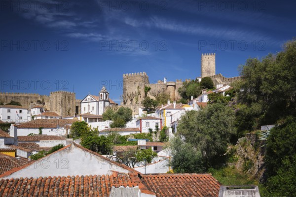 Obidos castle stands proudly above the old houses, showcasing Portugal's rich history and scenic