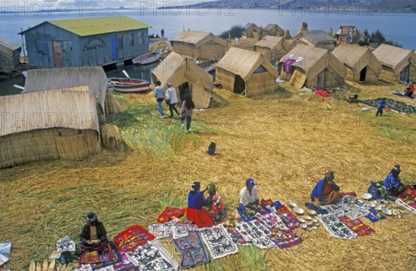 Sale of souvenirs, reed huts on a floating Uro island in Lake Titcaca, Andean highlands, Peru,