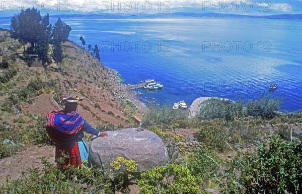 Traditionally dressed woman, port, Isla Taquile in Lake Titicaca, Andean highlands, Peru, South