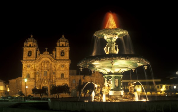 Illuminated fountain and cathedral on Placa de Armas, Cusco, Andean Highlands, South America,