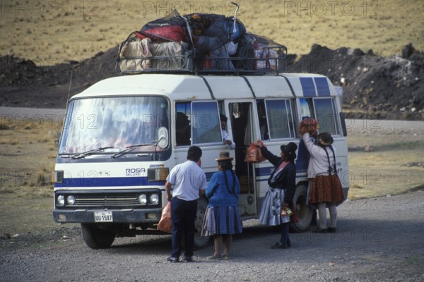 Women selling food on the side of the road to bus travelers, Andean highlands near Puno, Peru,