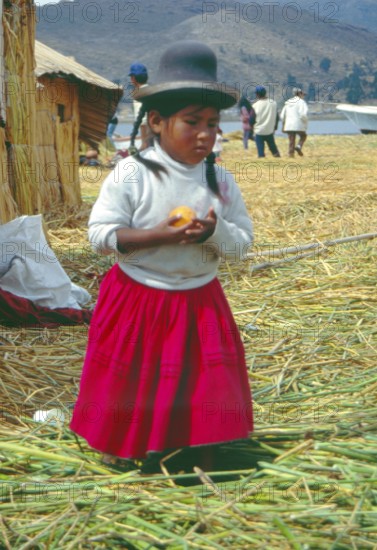 Little girl on a floating Uro island in Lake Titcaca, Andean highlands, Peru, South America,