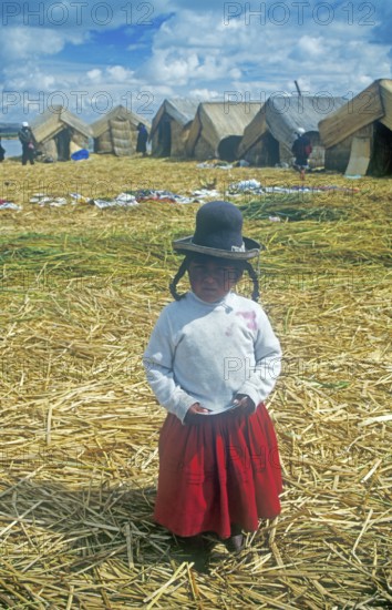 Portrait of a little girl on a floating Uro island in Lake Titcaca, Andean highlands, Peru, South