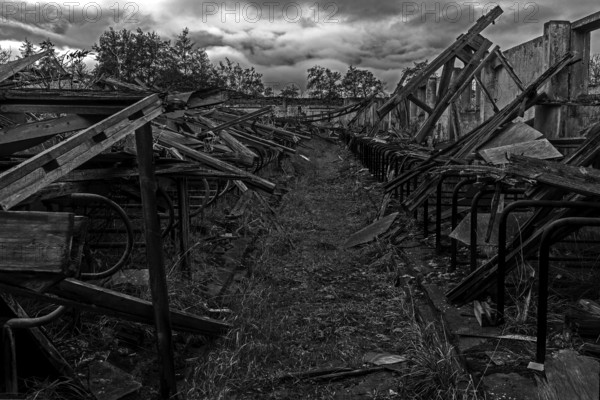 Dilapidated hall of the dilapidated plant of a former agricultural production cooperative of the