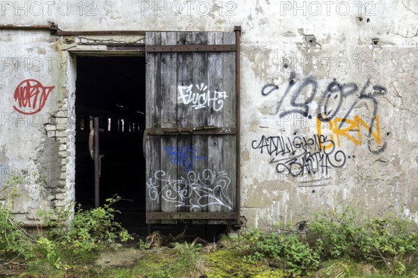 Wall with Grafity and Gate, dilapidated complex of a former agricultural production cooperative of