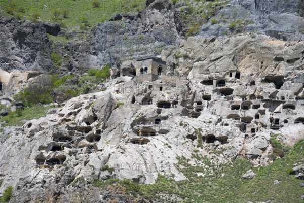 Close-up of caves artfully integrated into a rocky rock wall, cave town, cave monastery, Vardzia,