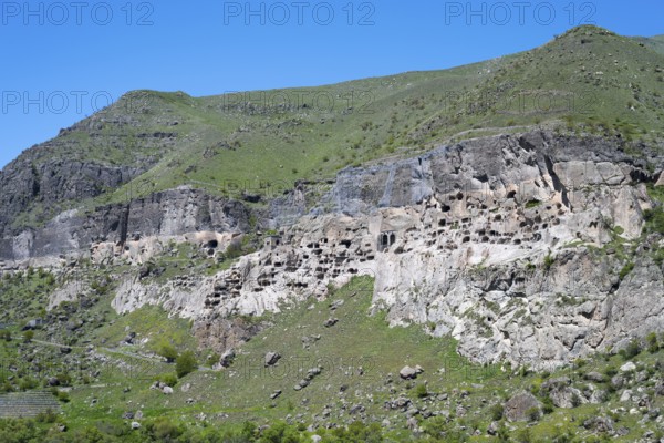 A rocky cliff wall with numerous caves on a hill, cave town, cave monastery, Vardzia,