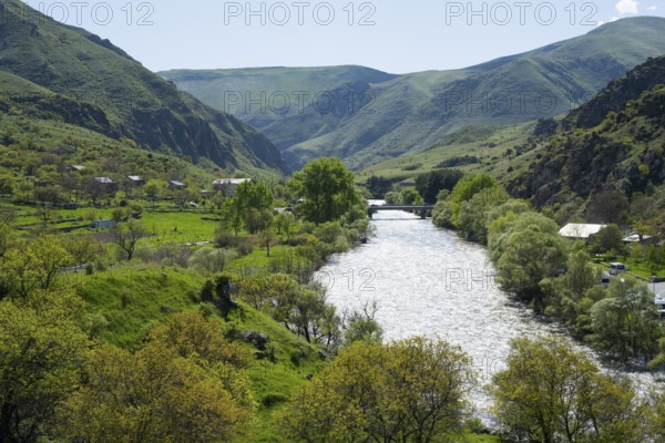Idyllic valley with a flowing river. Hilly landscape with lush greenery, Kura river, landscape near
