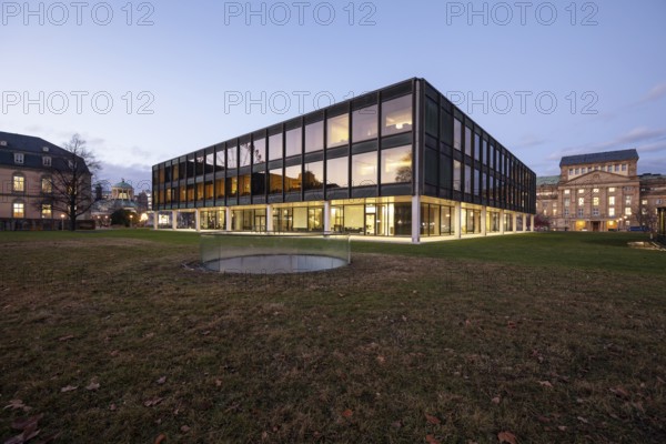 The state parliament of Stuttgart glows impressively in the evening. The architecture is