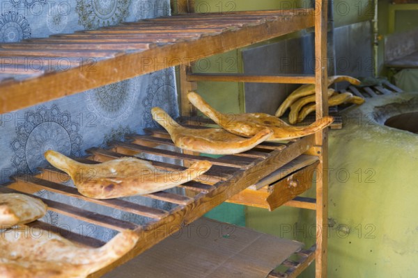 Fresh flatbread on rustic wooden shelves in a bakery, Samtskhe-Javakheti region,