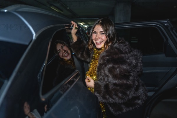 Young woman in a fur coat with gold tinsel smiles as she steps out of a car in a parking lot at