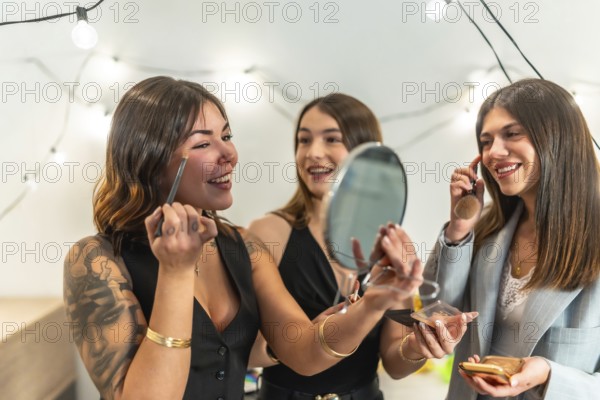 Three young women, best friends, getting ready and applying makeup at home before a new year's eve