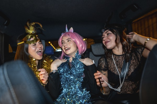 Three young women smiling, laughing, and having fun, dressed up in costumes with festive