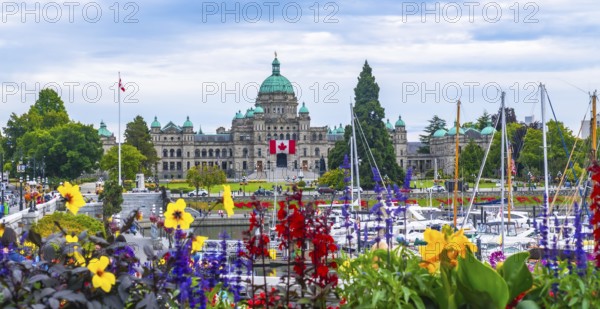 Colorful flowers decorate the inner harbour with the british columbia parliament buildings standing
