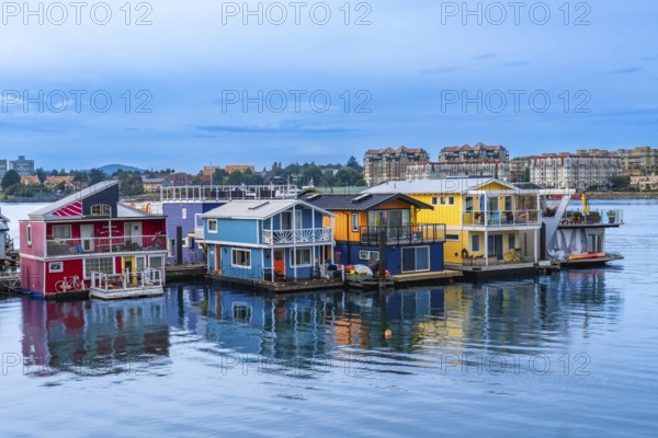 Fisherman's wharf park's vibrant floating homes create a picturesque scene reflecting in the calm