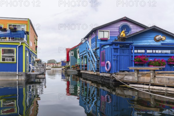 Fisherman's wharf park's brightly colored floating homes create a vibrant reflection in the calm
