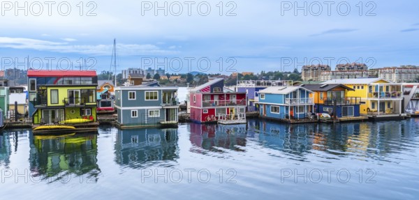 Fisherman's wharf park's vibrant houseboats create a picturesque scene, reflecting in the calm