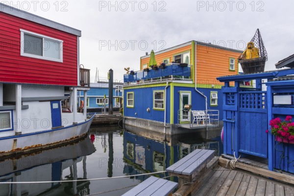 Fisherman's wharf park is showing its colorful floating homes in victoria, british columbia, a