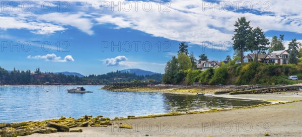 Tranquil coastal scene showcasing a motorboat sailing in the calm waters near the shores of
