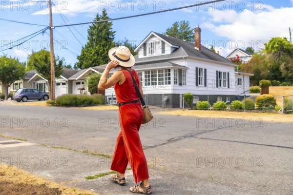 Tourist walking in a residential area of chemainus, a small town on vancouver island, british