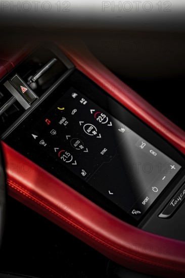 Close-up of a modern touchscreen control panel in a car with a red border, Porsche Taycan, Deer