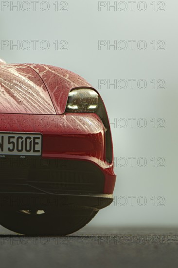 Close-up of a red vehicle with drops of water on the hood, Porsche Taycan, Deer Carsharing, Calw,